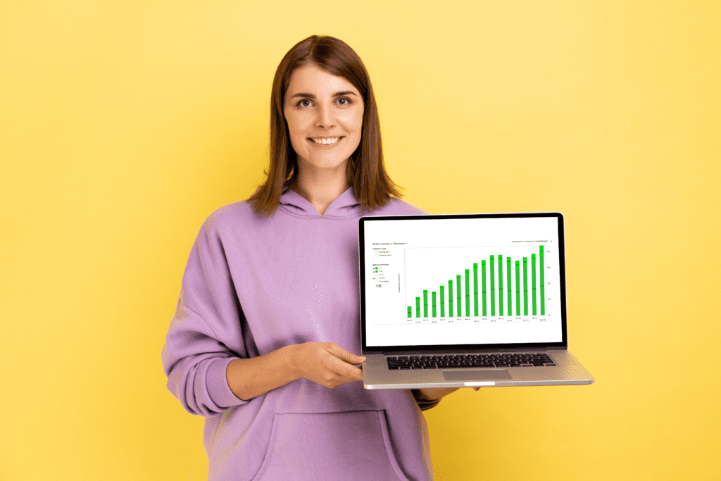 woman holding laptop with green bar chart