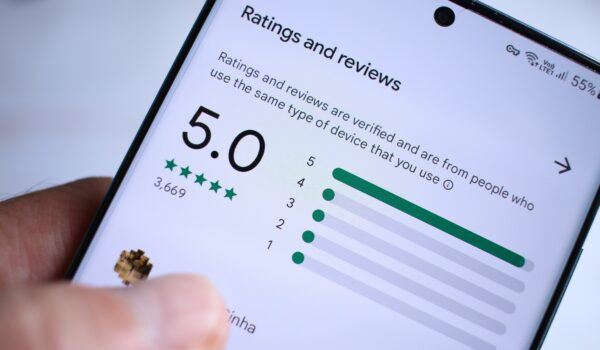 picture of a cellphone with a 5 star review listing pulled up on the screen.