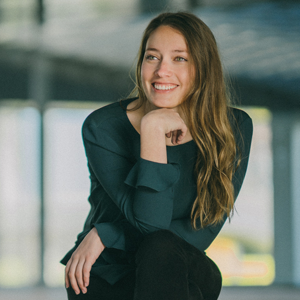Woman sitting with her legs crossed and smiling