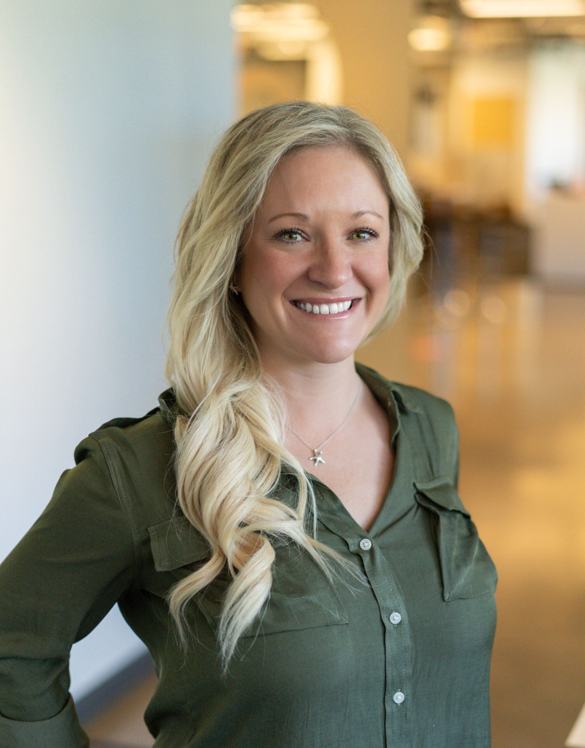 Woman standing with her hands on her hips and smiling